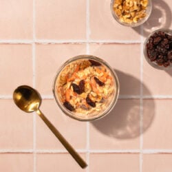carrot cake overnight oats with gold spoon and walnuts